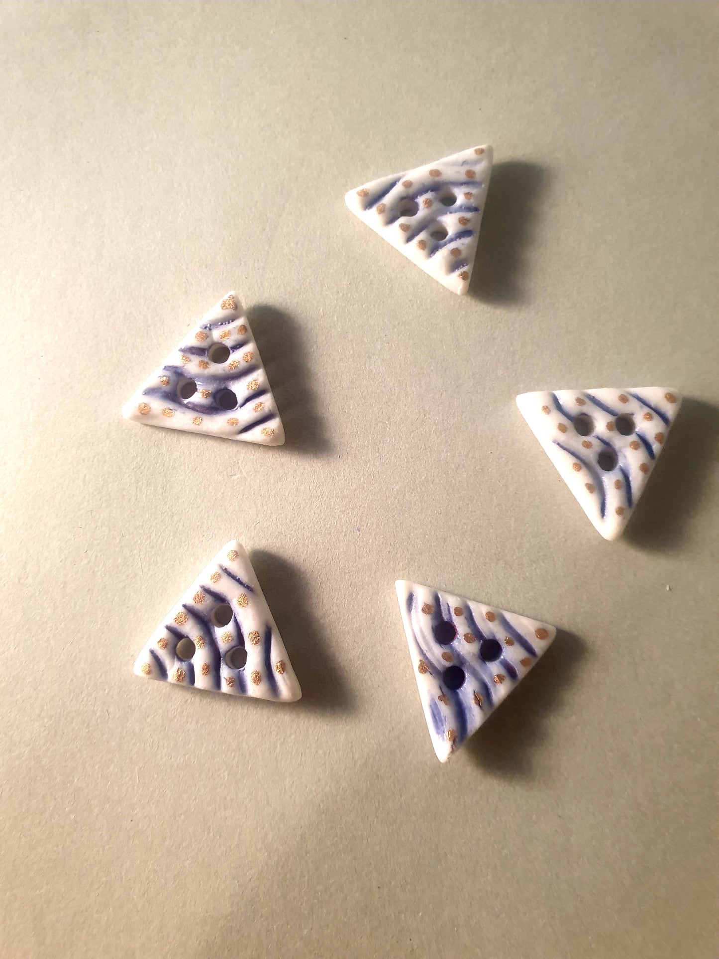 Triangular porcelain buttons.
